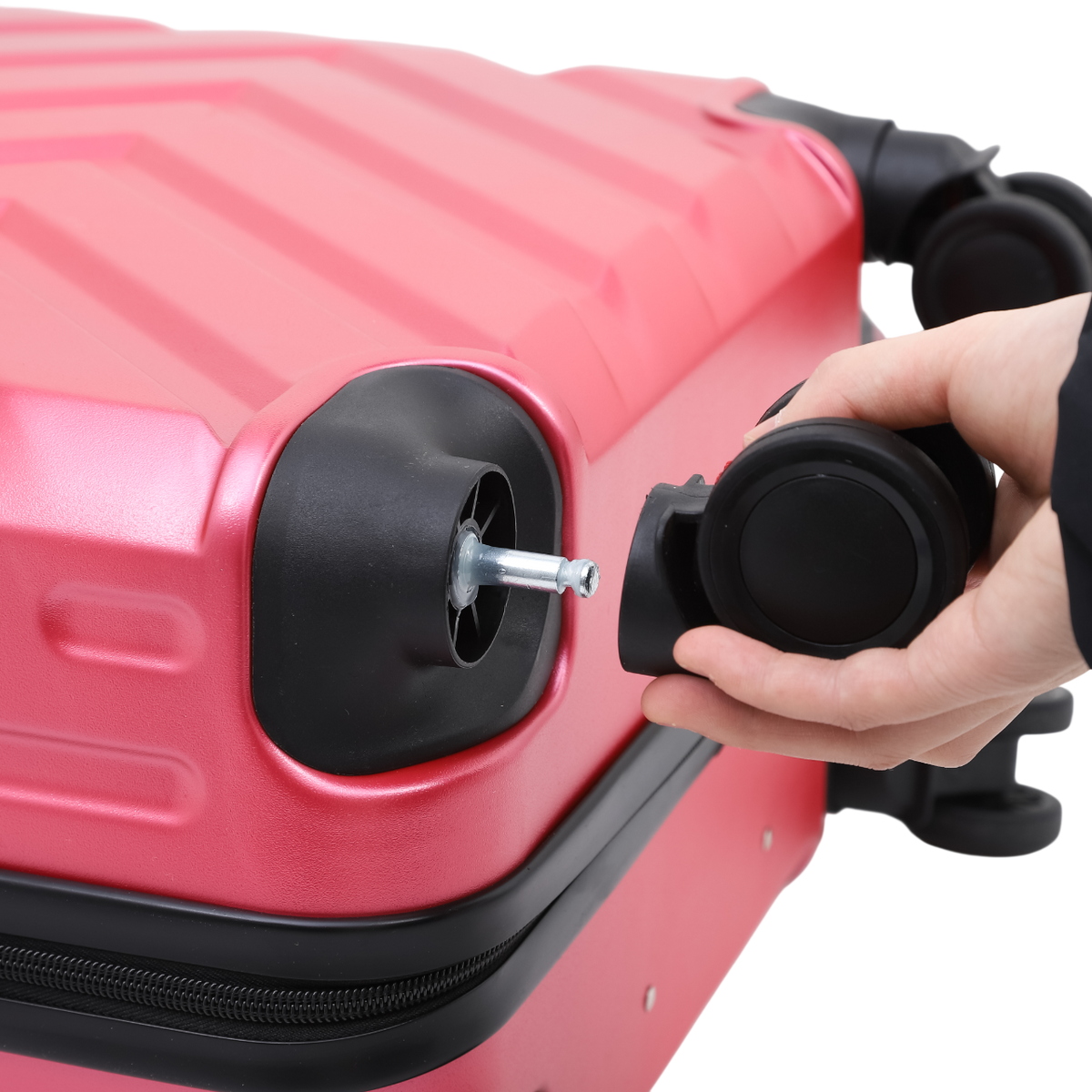 Suitcase in light pink with wheels and a zipper – black details, a person fitting a wheel